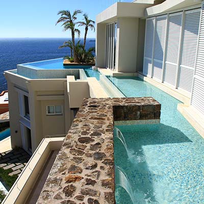 Water feature to swimming pool above living space.