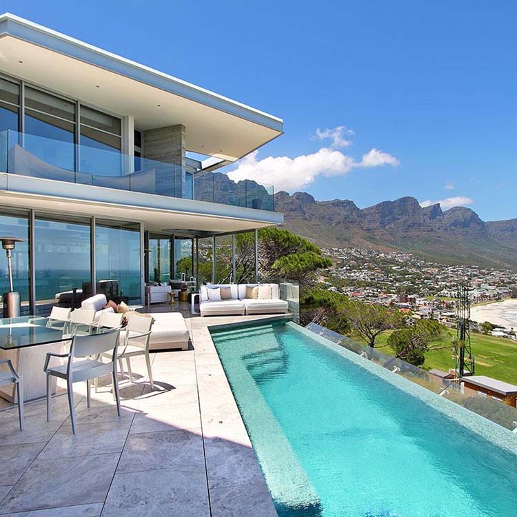 Dual waterproofed fully tiled rimflow pool with wind water level control system.