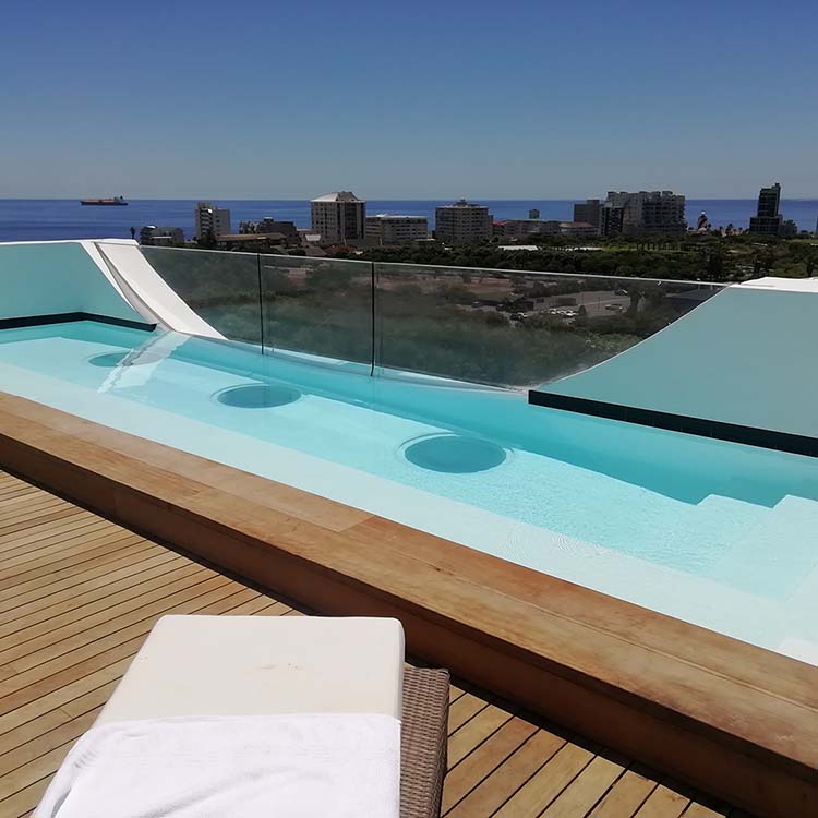 Dual waterproofed rooftop pool with Plexiglass wall and Plexiglass floor portholes.